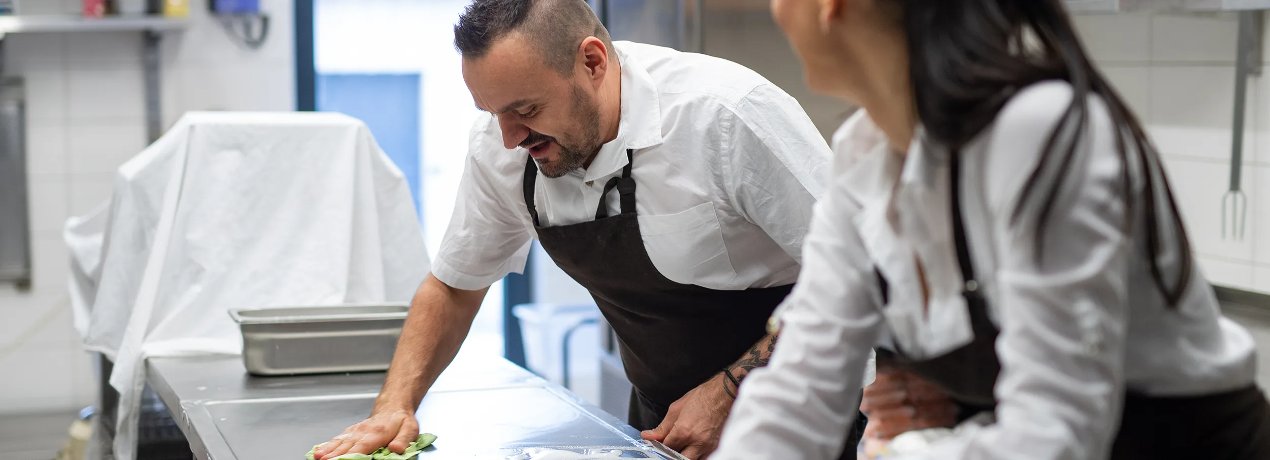 Restaurant employees cleaning surfaces